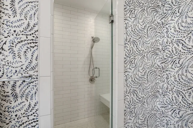 a living room with furniture a flat screen tv and a window