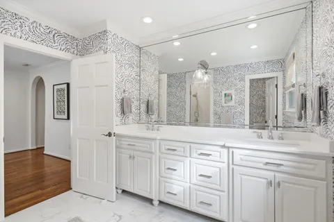 a bathroom with a sink a mirror and a toilet