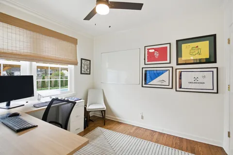 a bedroom with furniture and a flat screen tv
