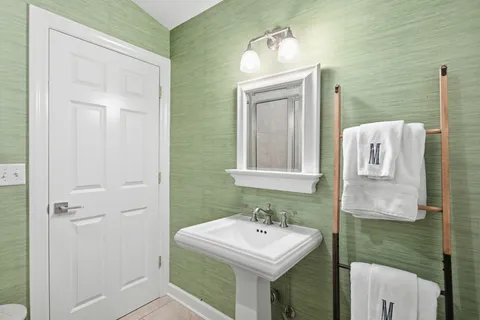 a kitchen with a refrigerator and a stove top oven