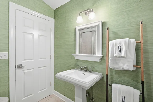 a kitchen with a refrigerator and a stove top oven
