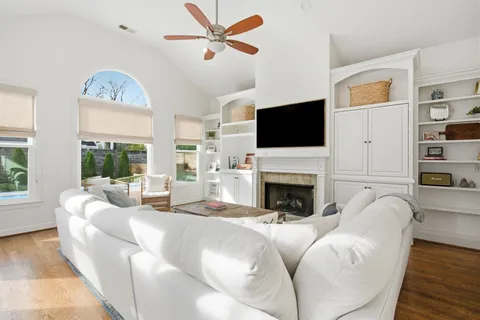 a living room with fireplace furniture and a flat screen tv