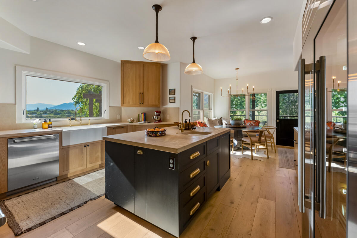 13100 Ojai Road Santa Paula, CA 93060 - Photo 19 of 60 a kitchen with kitchen island a sink stove and a dining table with garden view