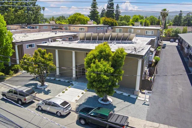 a view of a patio with table and chairs potted plants