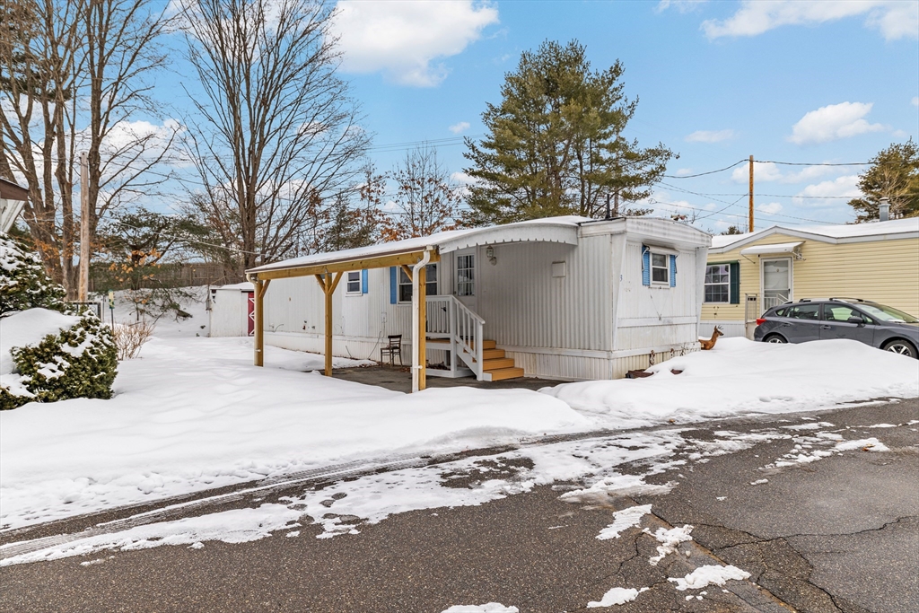 365 Main Street, Unit 3 Sturbridge, MA 01566 - Photo 2 of 20 a view of a white house with a snow on the side of the road
