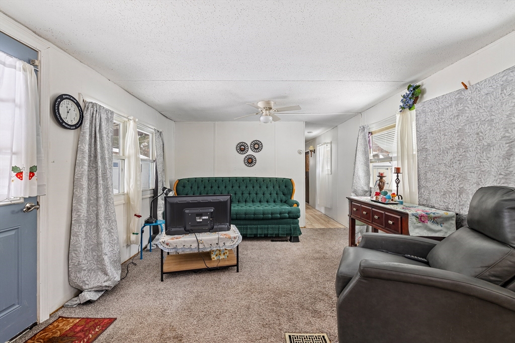 365 Main Street, Unit 3 Sturbridge, MA 01566 - Photo 5 of 20 a living room with furniture and a chandelier