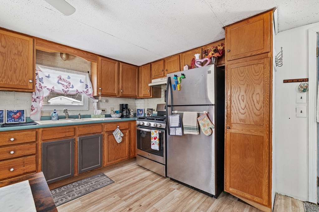 365 Main Street, Unit 3 Sturbridge, MA 01566 - Photo 8 of 20 a kitchen with stainless steel appliances granite countertop a refrigerator and a sink