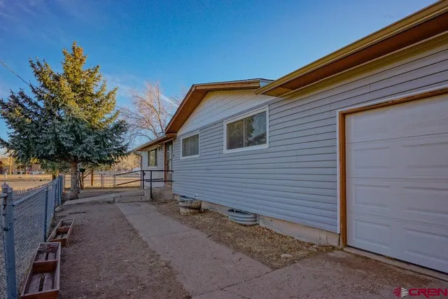 a backyard of a house with shaded area