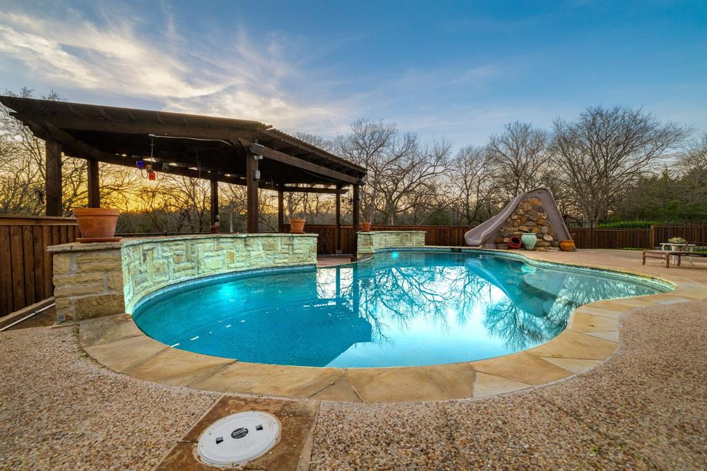 689 Jim Cannon Road Van Alstyne, TX 75495 - Photo 34 of 35 View of swimming pool featuring a water slide, a fenced backyard, and patio surround
