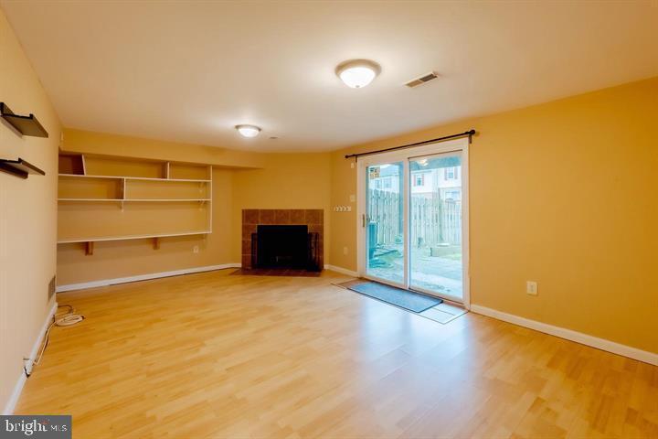 30 Wellspring Circle Owings Mills, MD 21117 - Photo 11 of 19 a view of an empty room with a fireplace and a window