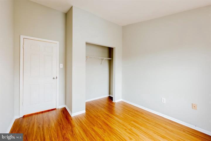 30 Wellspring Circle Owings Mills, MD 21117 - Photo 16 of 19 a bedroom with a bed and a lamp on the wall