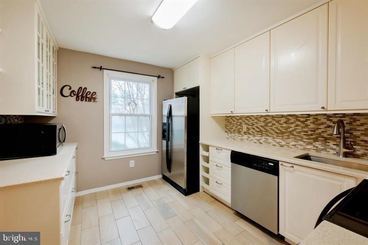 30 Wellspring Circle Owings Mills, MD 21117 - Photo 4 of 19 a kitchen with granite countertop white cabinets and white appliances