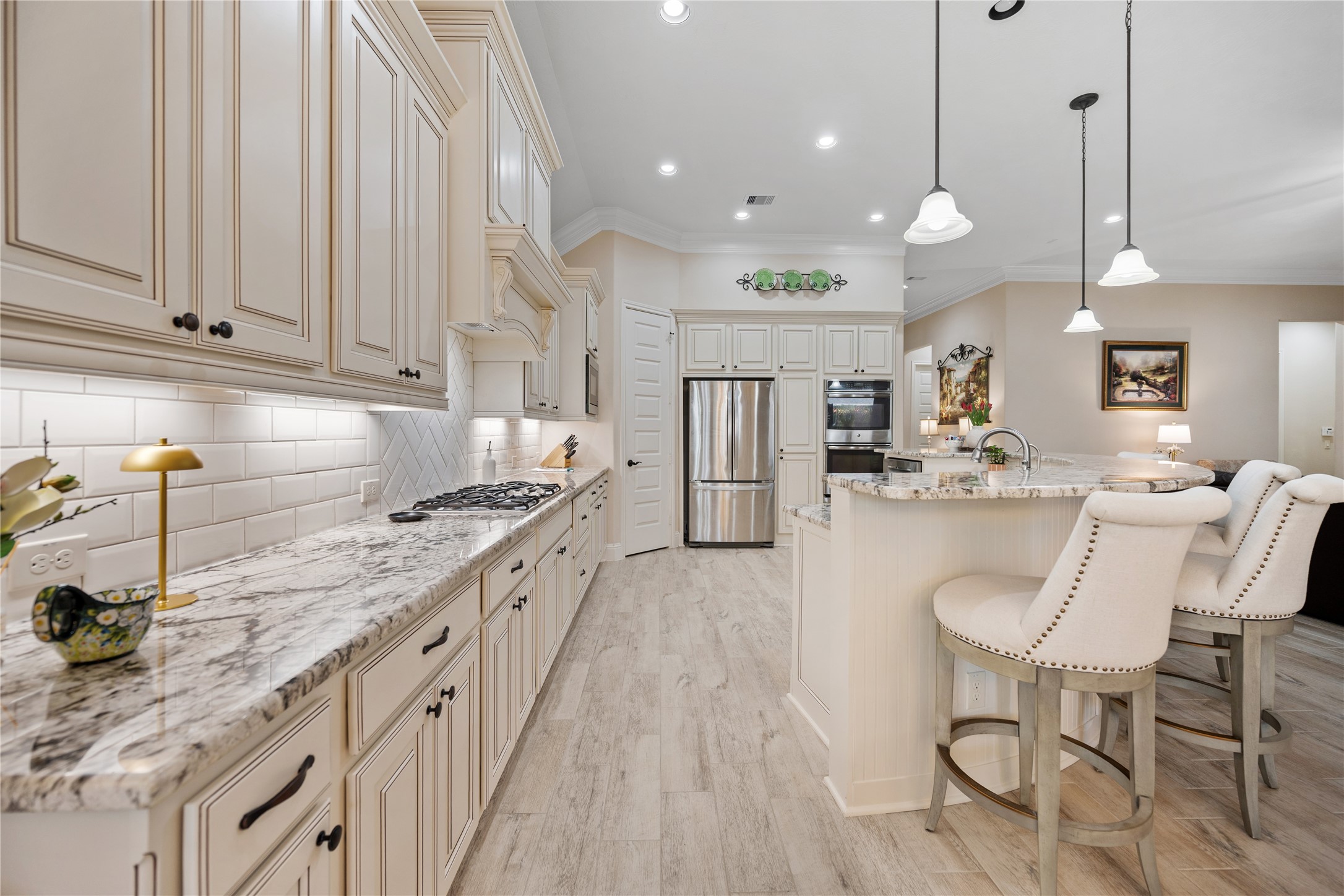 19911 Cullen Ridge Drive Porter, TX 77365 - Photo 15 of 42 a kitchen with stainless steel appliances granite countertop a sink a stove and a wooden floors