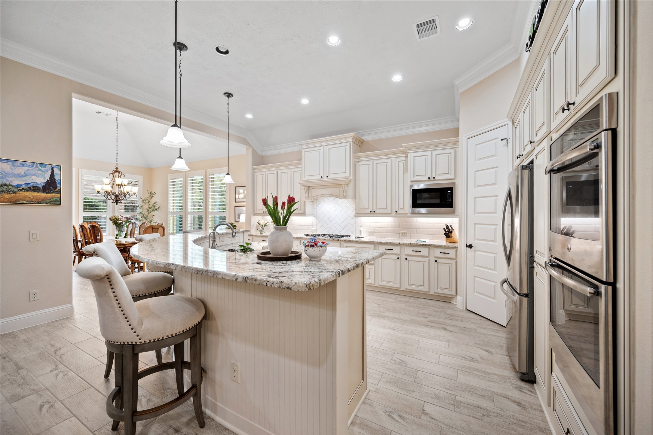 19911 Cullen Ridge Drive Porter, TX 77365 - Photo 16 of 42 a kitchen with stainless steel appliances granite countertop a refrigerator a sink dishwasher a stove and white cabinets with wooden floor
