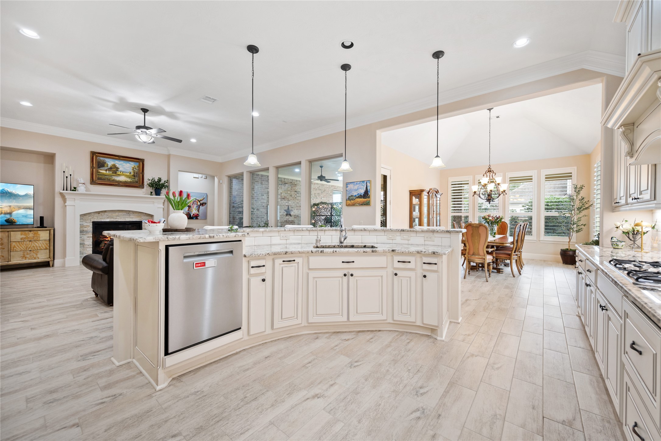 19911 Cullen Ridge Drive Porter, TX 77365 - Photo 17 of 42 a large kitchen with kitchen island a large counter space a sink appliances and living room view