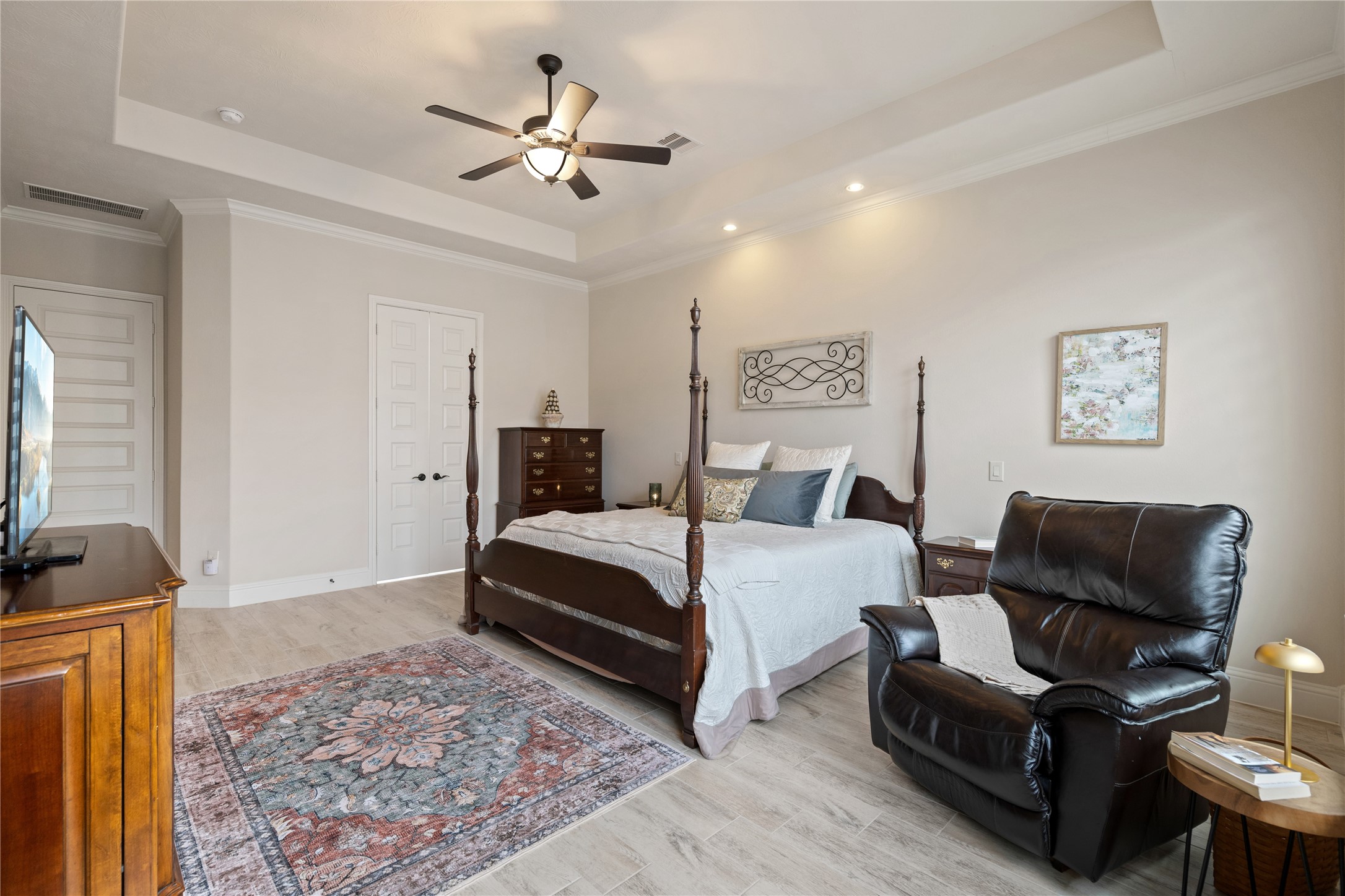 19911 Cullen Ridge Drive Porter, TX 77365 - Photo 21 of 42 a bedroom with a bed a couch and a chandelier