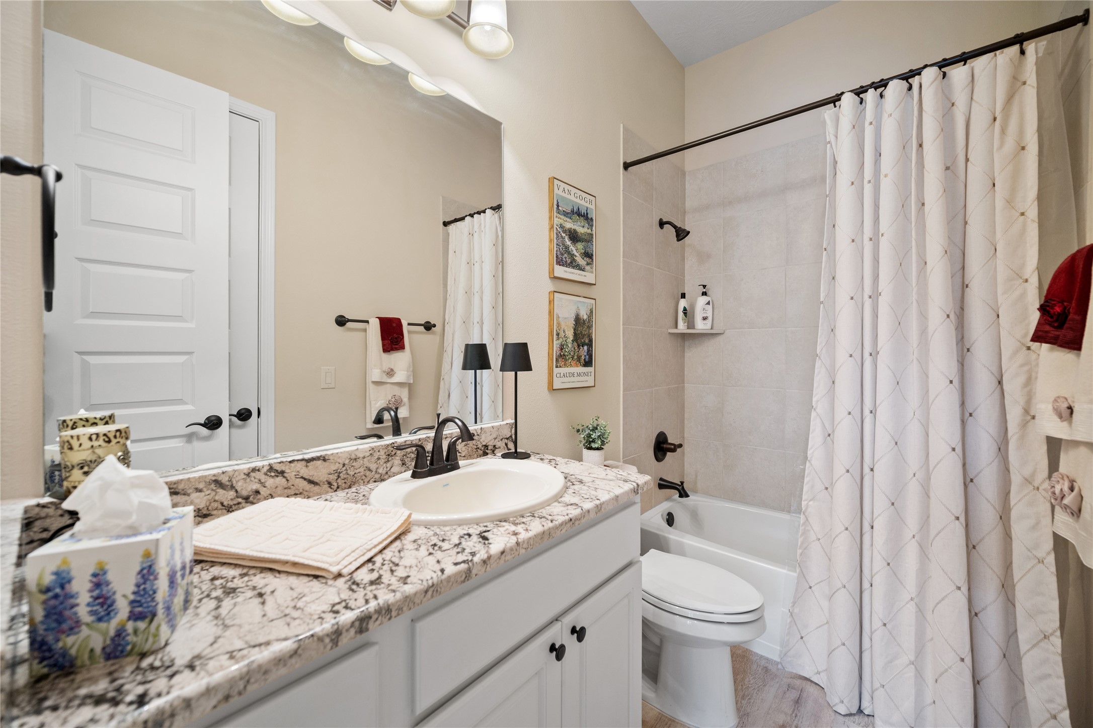 19911 Cullen Ridge Drive Porter, TX 77365 - Photo 29 of 42 a bathroom with a granite countertop sink toilet and shower