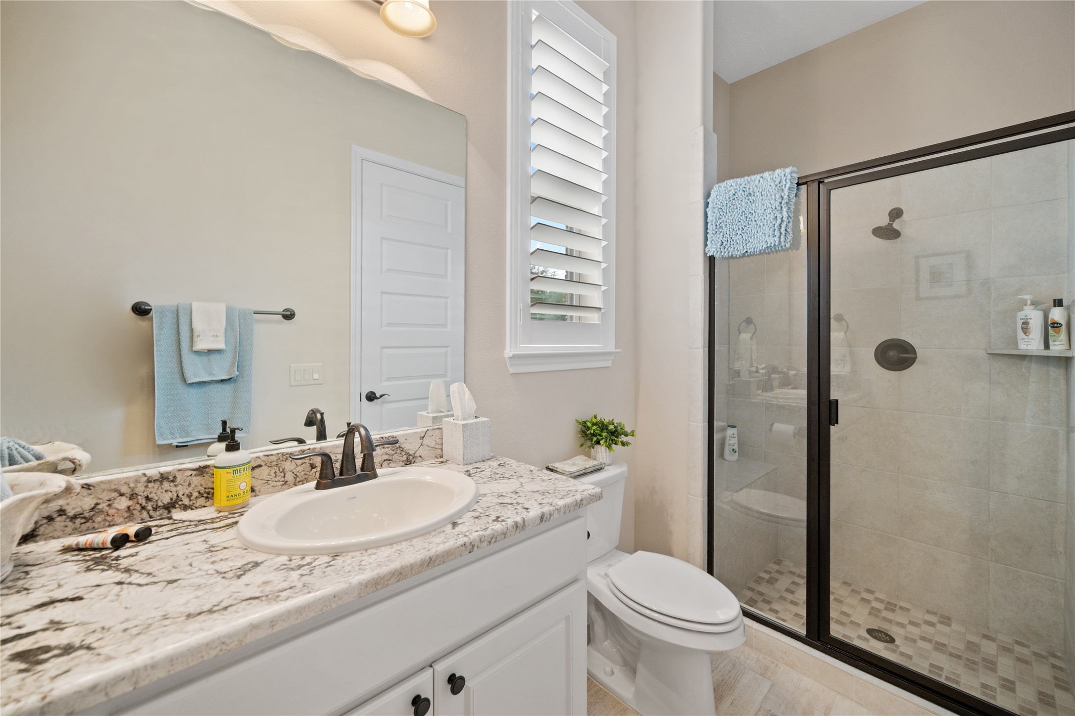 19911 Cullen Ridge Drive Porter, TX 77365 - Photo 30 of 42 a bathroom with a granite countertop sink toilet and shower