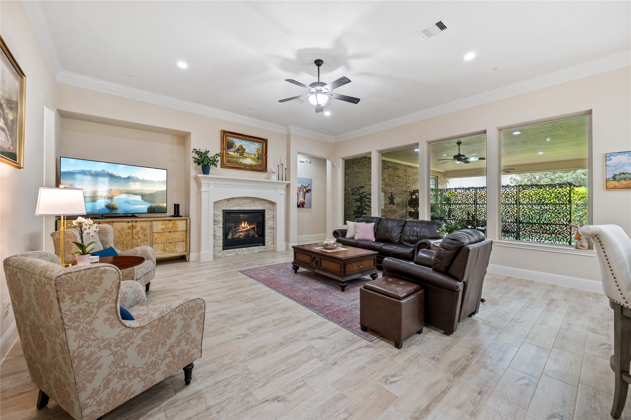 19911 Cullen Ridge Drive Porter, TX 77365 - Photo 6 of 42 a living room with furniture a fireplace and a large window