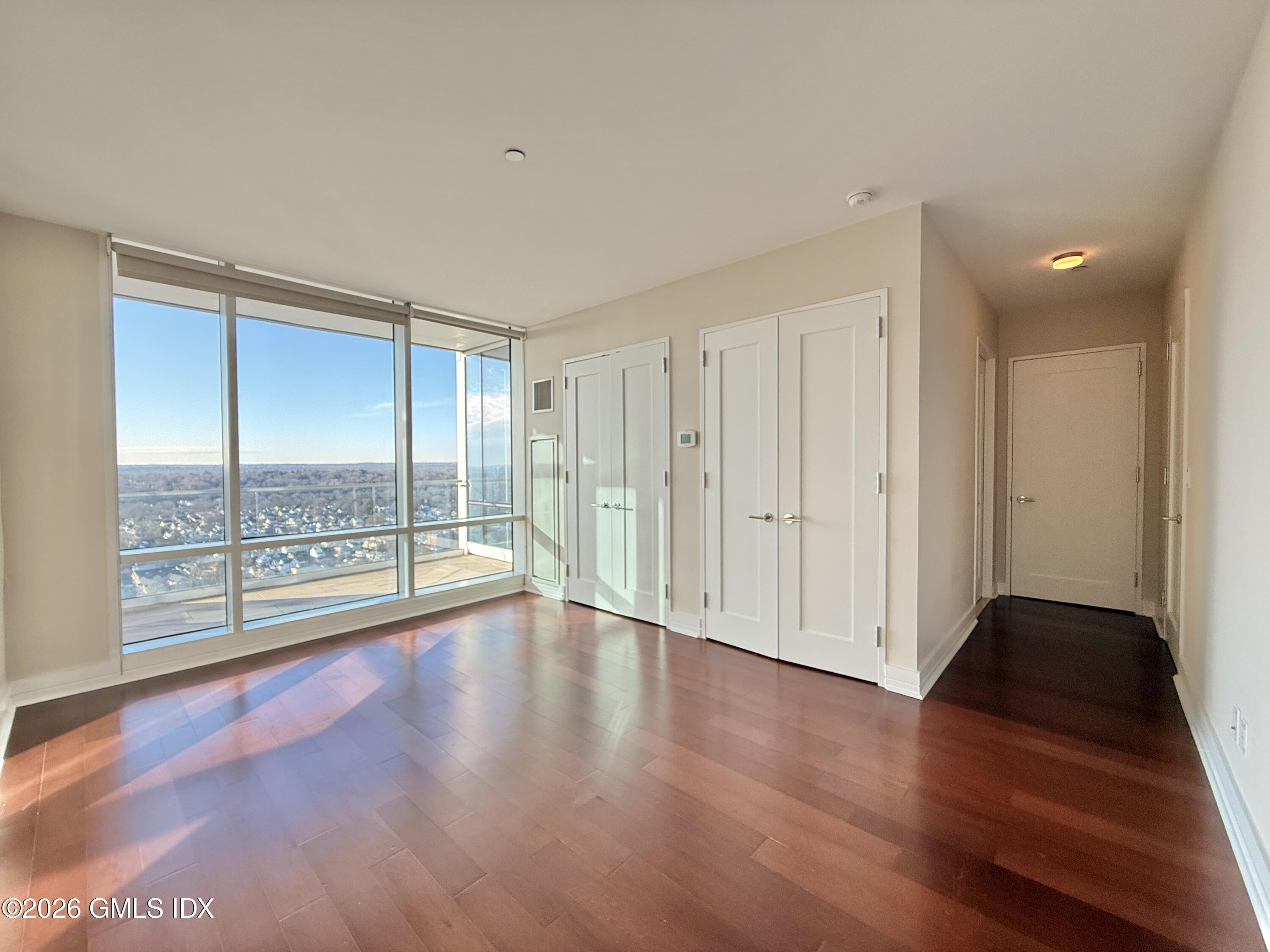 1 Broad Street, Unit PHD2 Stamford, CT 06901 - Photo 11 of 19 a view of room with window and wooden floor