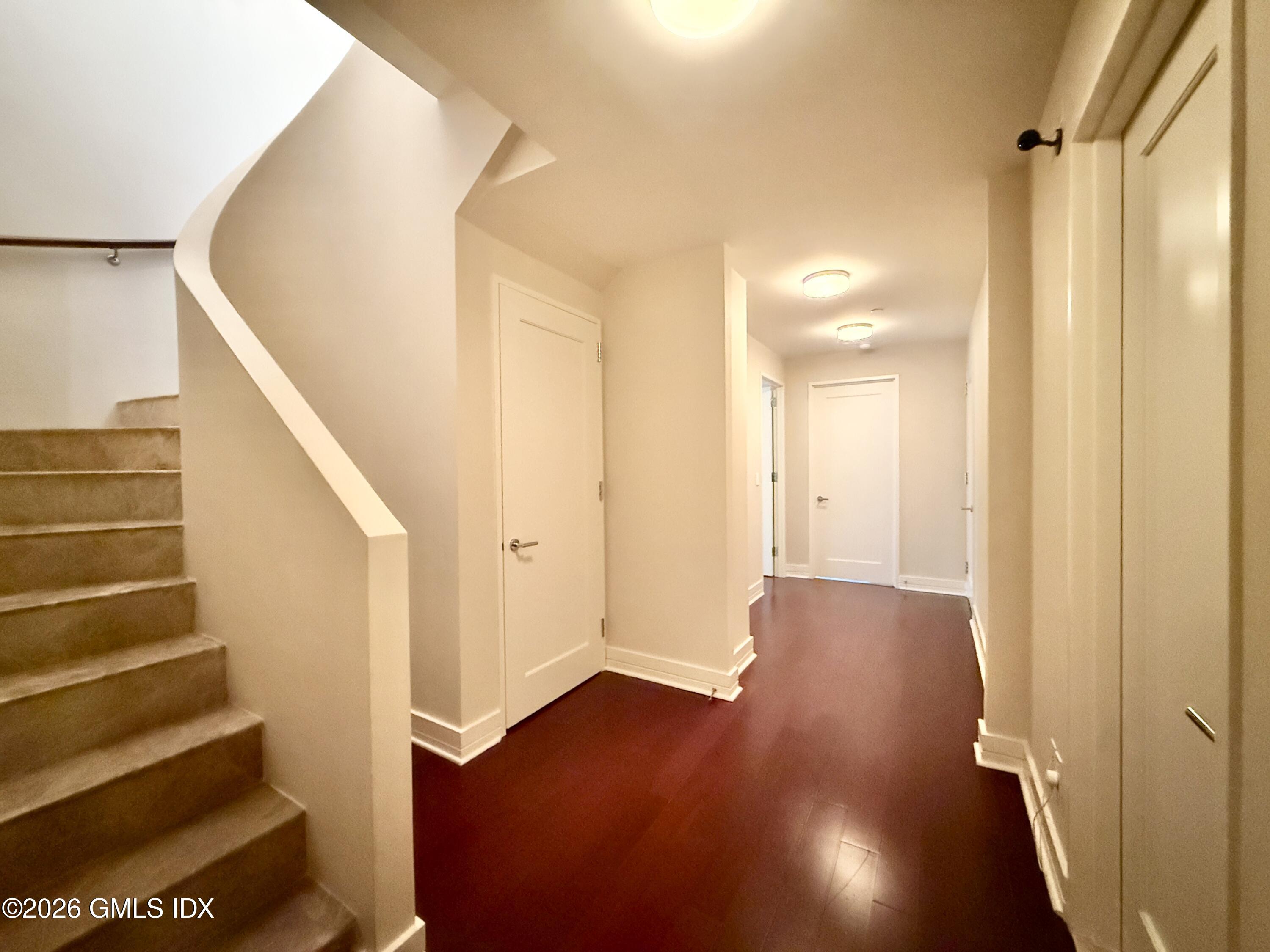 1 Broad Street, Unit PHD2 Stamford, CT 06901 - Photo 7 of 19 a view of a hallway with wooden floor and staircase