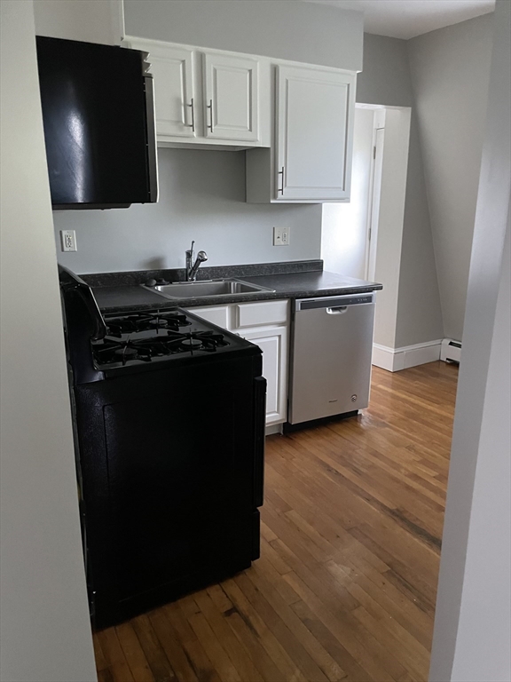 34 Herbert Street, Unit 6 Lynn, MA 01902 - Photo 2 of 9 a kitchen with a stove and a microwave