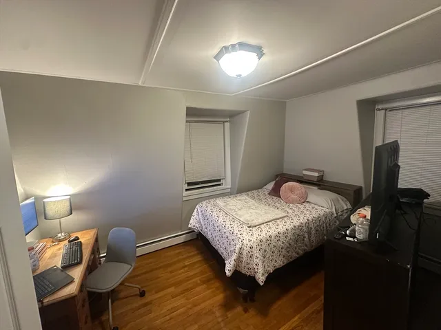 a bedroom with a bed and a lamp on table