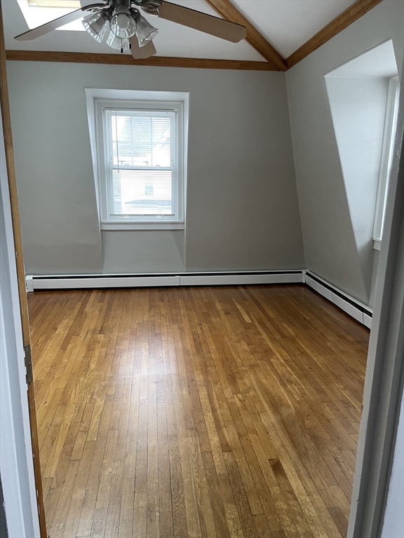34 Herbert Street, Unit 6 Lynn, MA 01902 - Photo 7 of 9 an empty room with wooden floor and windows