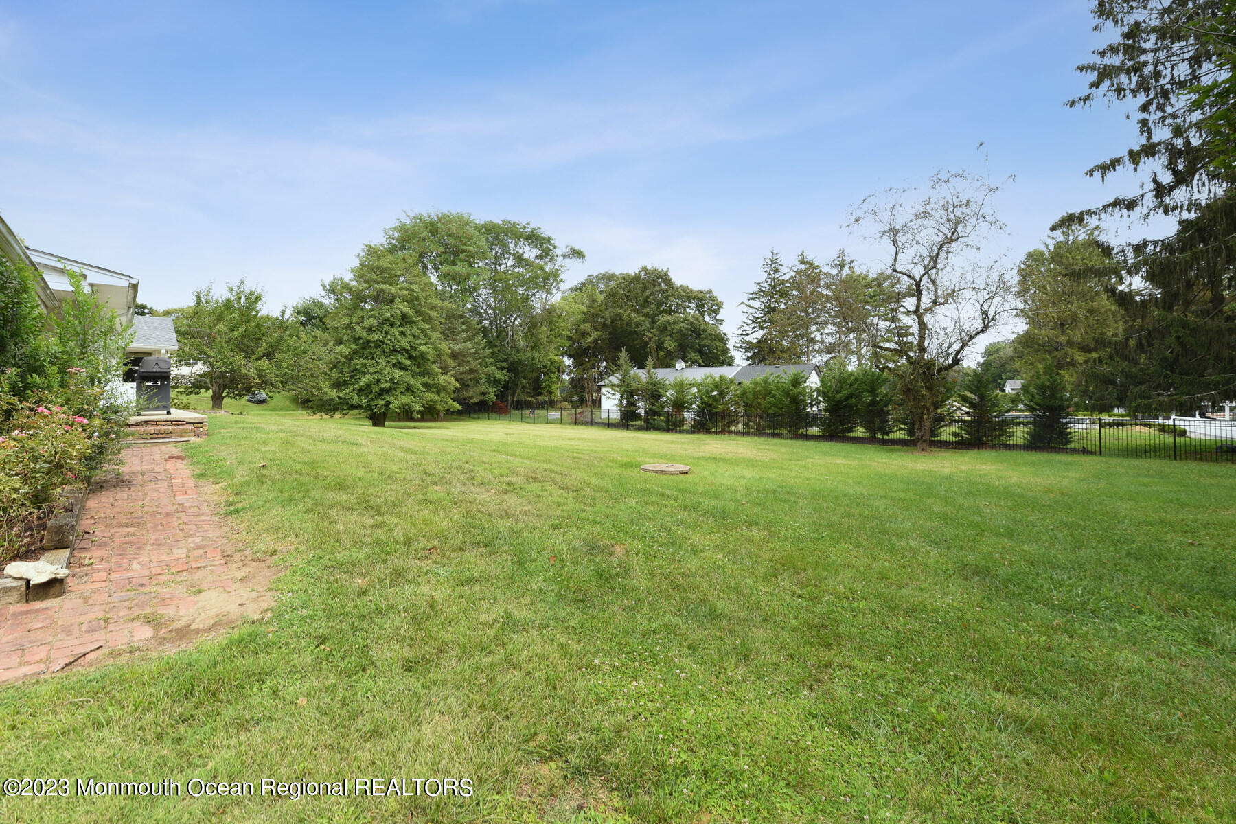 29 Willow Brook Road Holmdel, NJ 07733 - Photo 22 of 35 a backyard of a house with lots of green space and fog