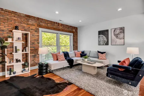 a living room with furniture and a rug