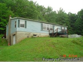 300 Elk Lake Road Springville, PA 18844 - Photo 1 of 1 a backyard of a house with wooden deck and wooden fence
