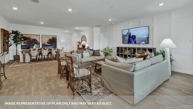 a living room with furniture and a view of kitchen