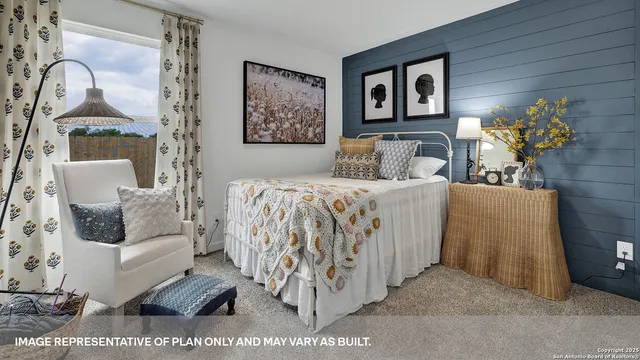 a view of a backyard with plants and large tree