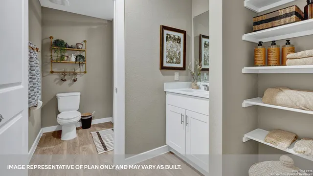a bathroom with a toilet and a shower curtain