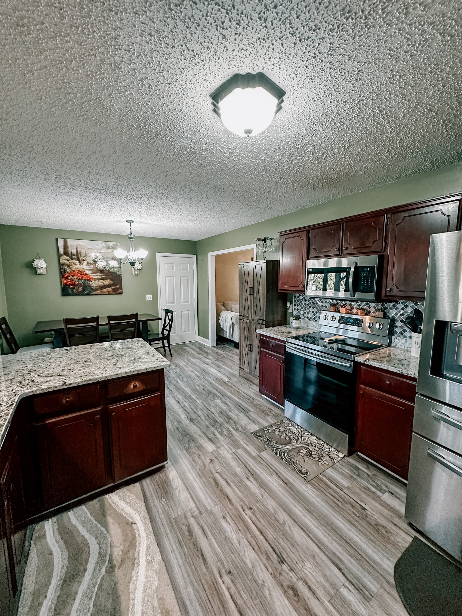5124 East Calgary Murfreesboro, TN 37129 - Photo 3 of 32 a large kitchen with stainless steel appliances granite countertop a stove refrigerator and a view of living room