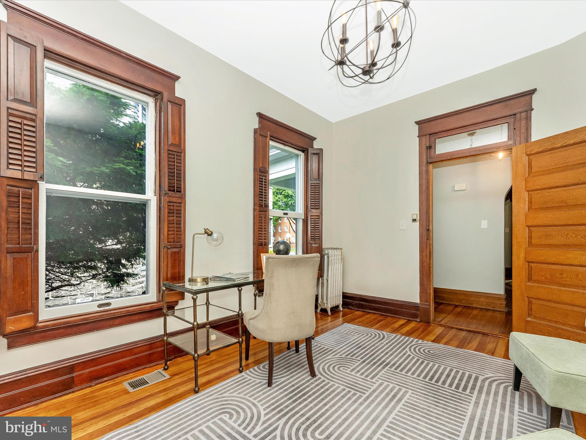 18 Clarke Place Frederick, MD 21701 - Photo 28 of 74 a living room with a couch and a table with wooden floor