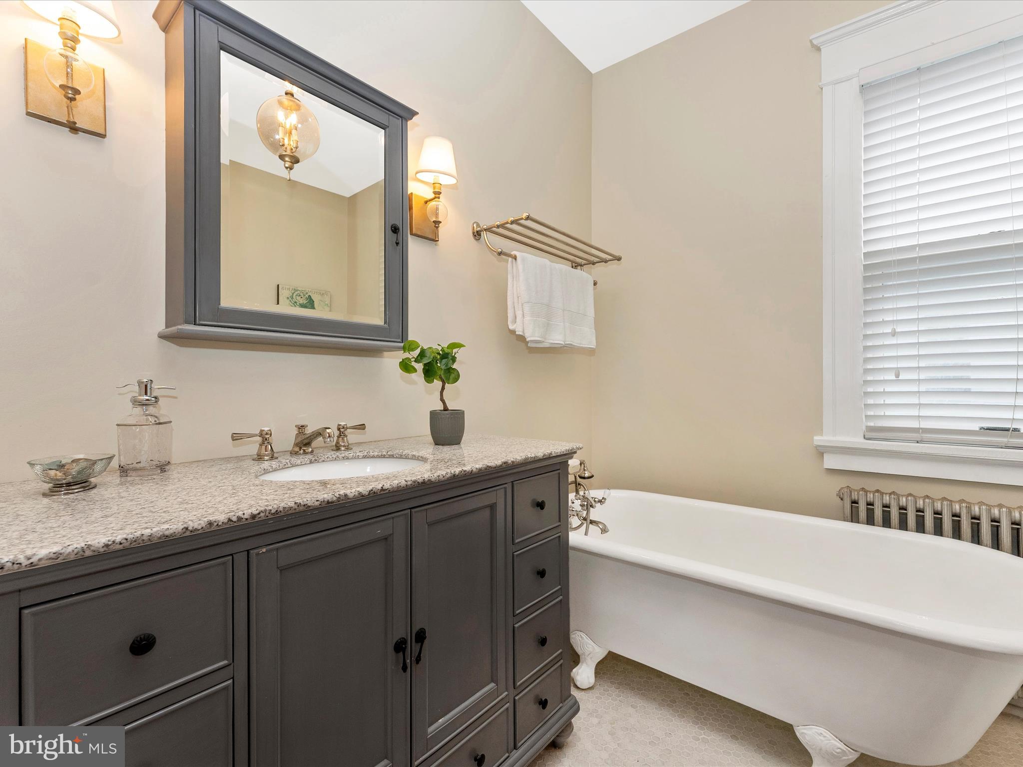 18 Clarke Place Frederick, MD 21701 - Photo 43 of 74 a bathroom with a granite countertop sink mirror and a bathtub