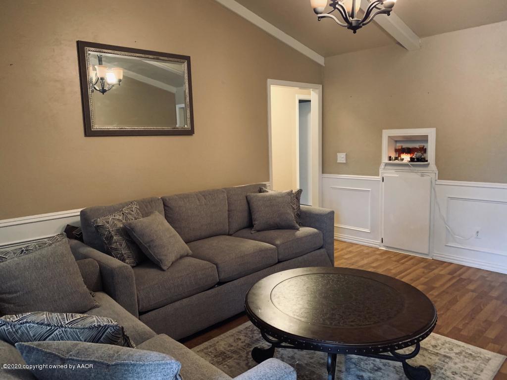 4354 South Polk Street Amarillo, TX 79110 - Photo 6 of 12 a living room with furniture and a chair