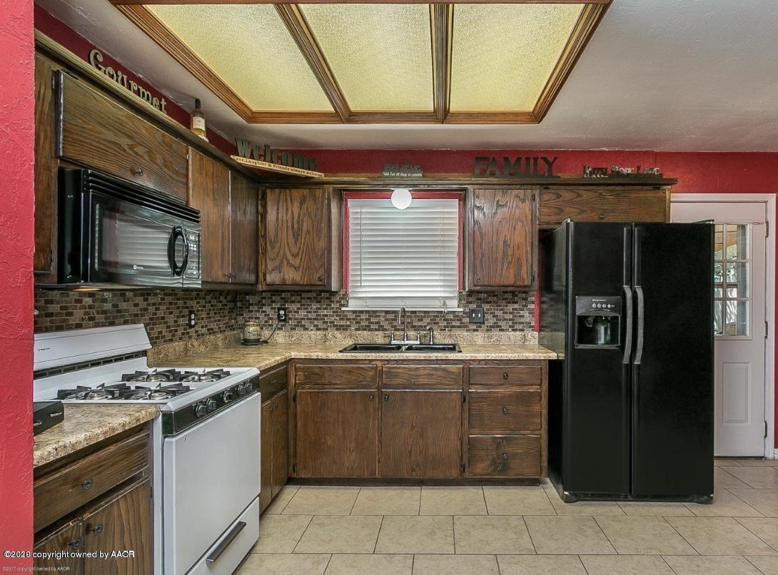 4354 South Polk Street Amarillo, TX 79110 - Photo 7 of 12 a kitchen with stainless steel appliances granite countertop a stove a refrigerator and a oven