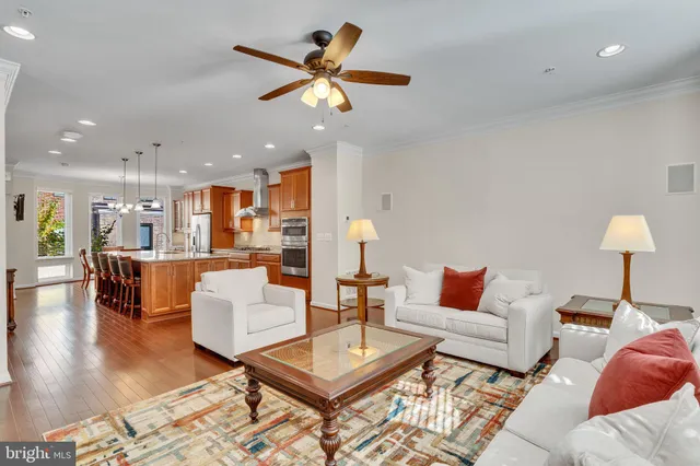 a living room with furniture and a view of kitchen