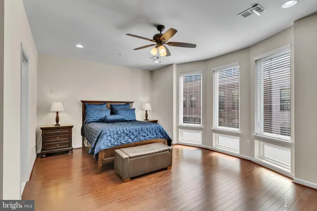 a bedroom with a large bed and a large window
