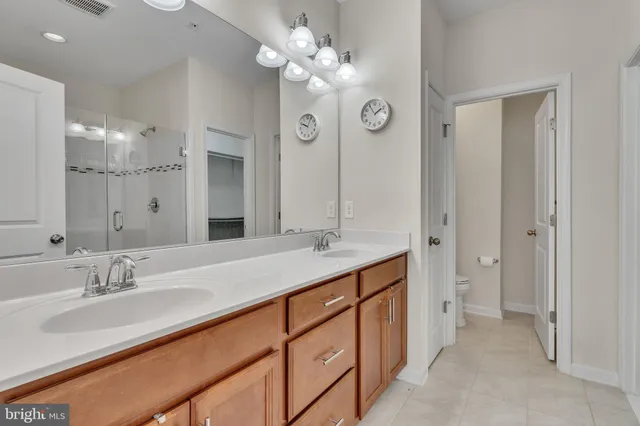 a bathroom with a sink vanity and a mirror
