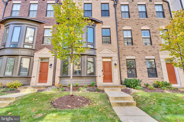 front view of a brick house with a yard