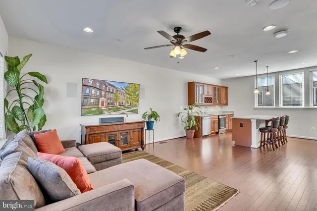 a living room with furniture and wooden floor