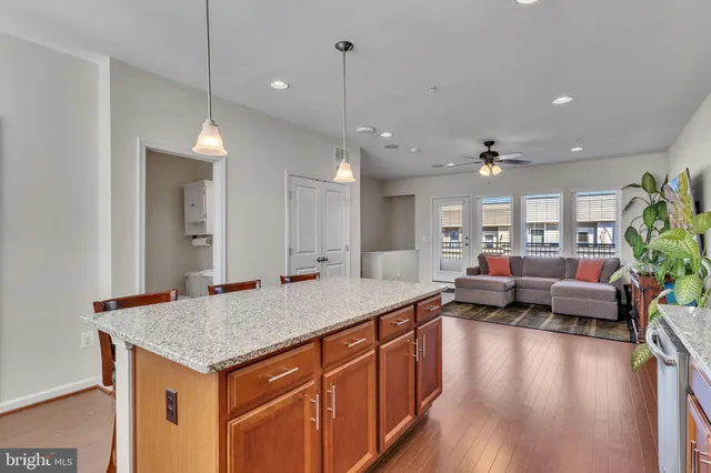 a open kitchen with stainless steel appliances granite countertop a stove and a kitchen island