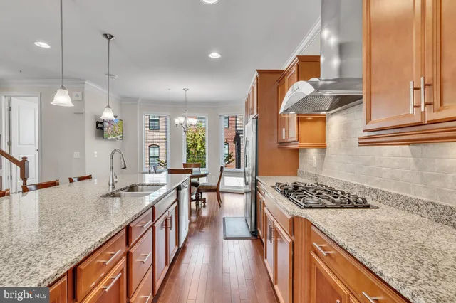 a kitchen with stainless steel appliances granite countertop sink stove and cabinets