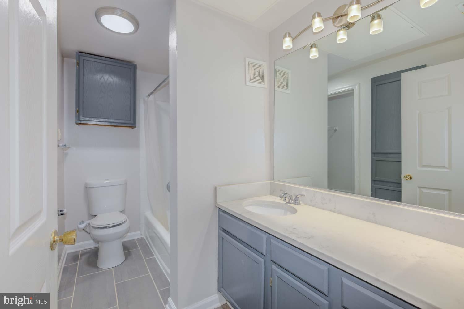 1530 Spring Gate Dr., Unit 9213 McLean, VA 22102 - Photo 14 of 24 a bathroom with a sink a toilet and a mirror