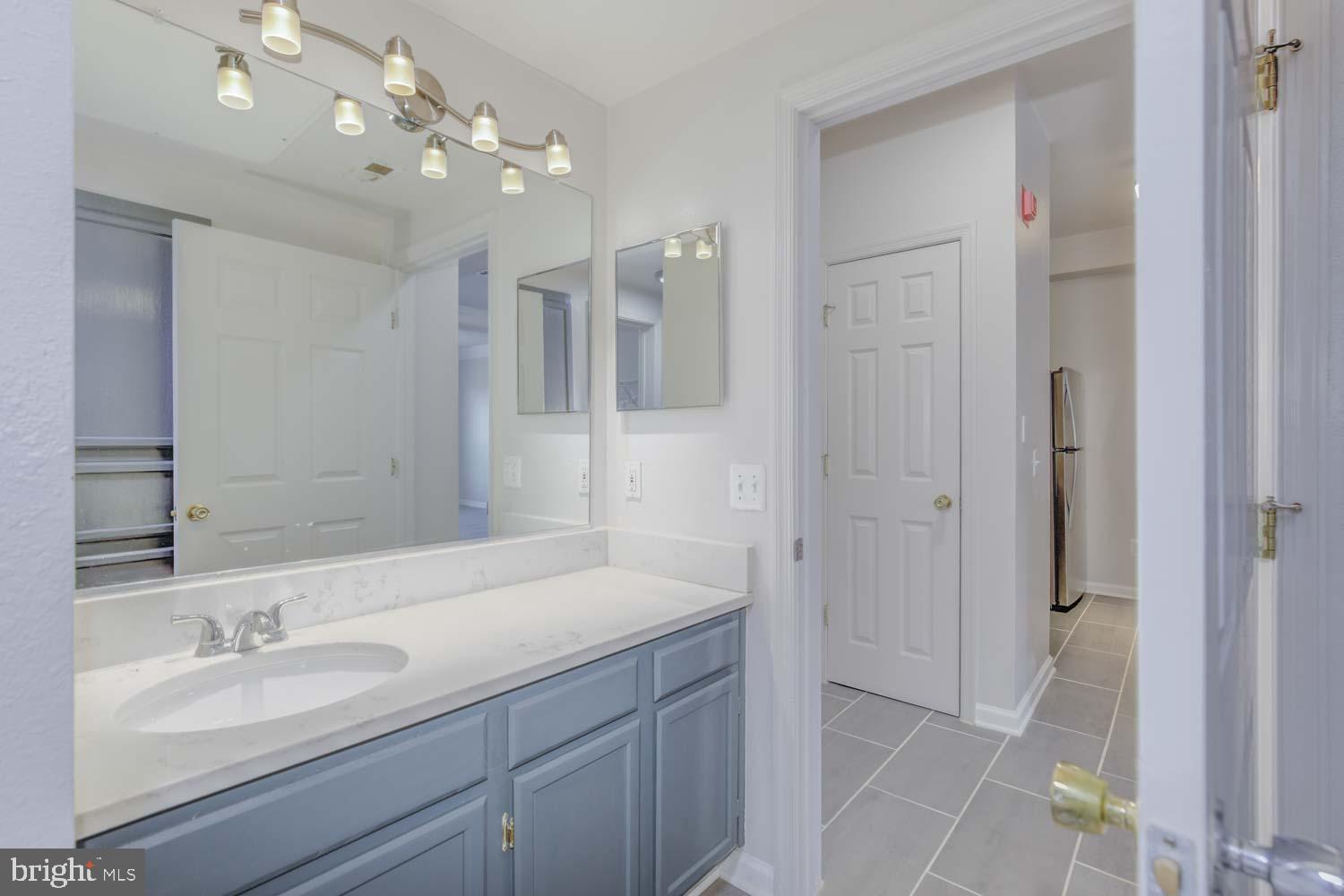1530 Spring Gate Dr., Unit 9213 McLean, VA 22102 - Photo 16 of 24 a bathroom with a sink double vanity granite tub and a mirror