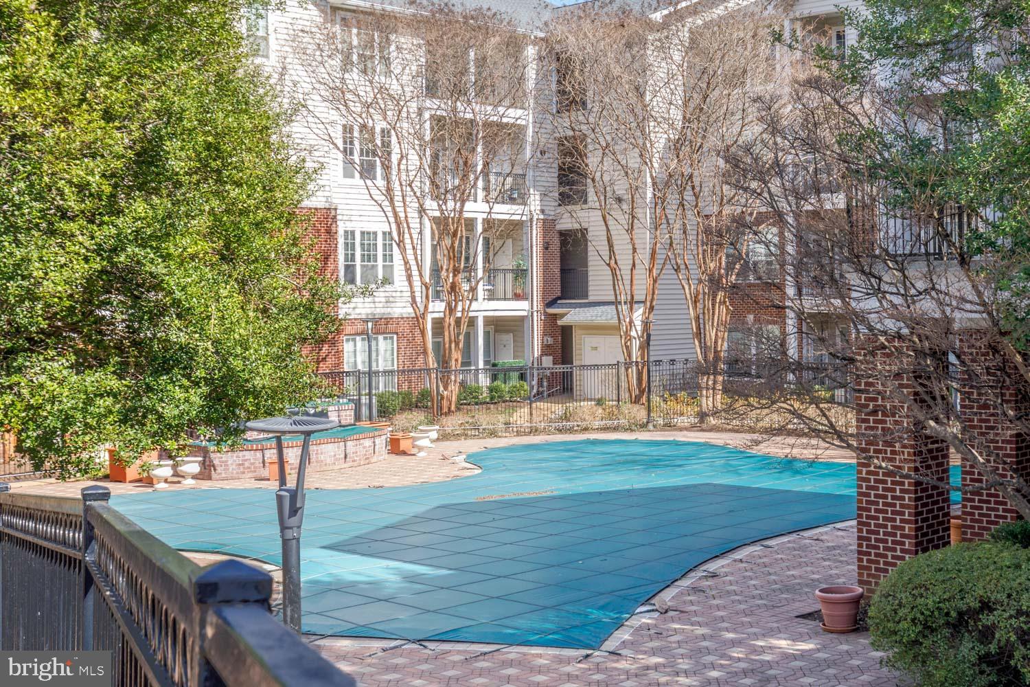 1530 Spring Gate Dr., Unit 9213 McLean, VA 22102 - Photo 20 of 24 a front view of a house with a yard