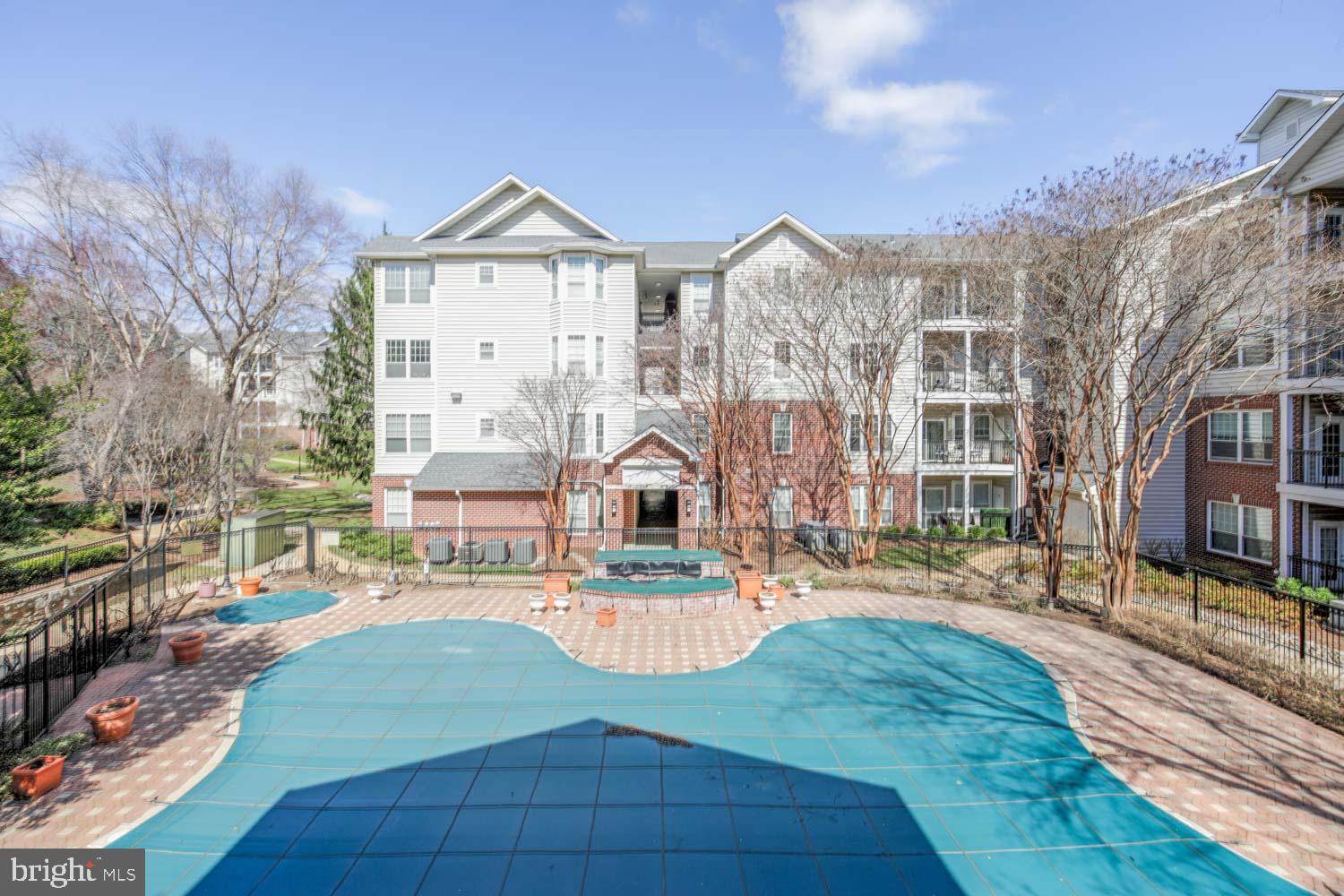 1530 Spring Gate Dr., Unit 9213 McLean, VA 22102 - Photo 21 of 24 a view of a big room with large windows and a yard